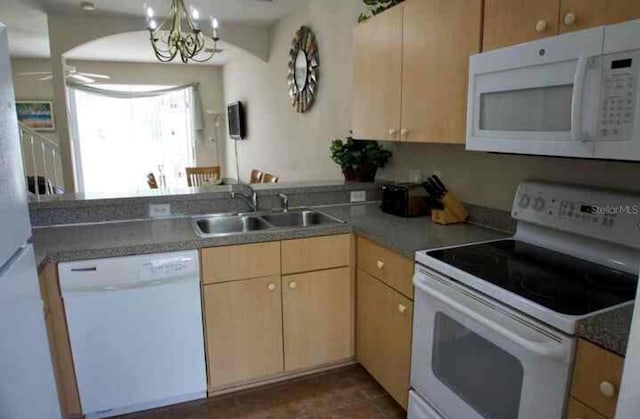 kitchen with ceiling fan with notable chandelier, white appliances, light brown cabinetry, and sink