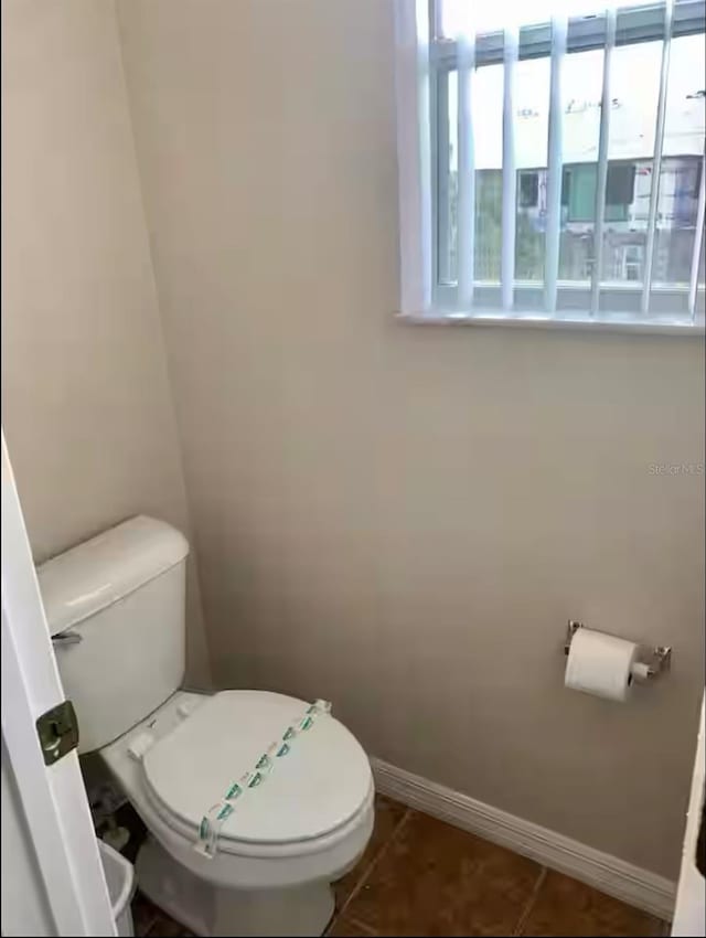 bathroom with tile patterned flooring and toilet