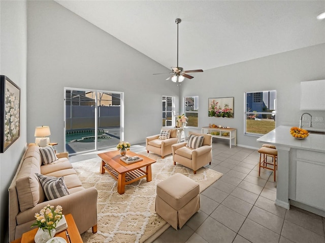 tiled living room featuring sink, high vaulted ceiling, and ceiling fan