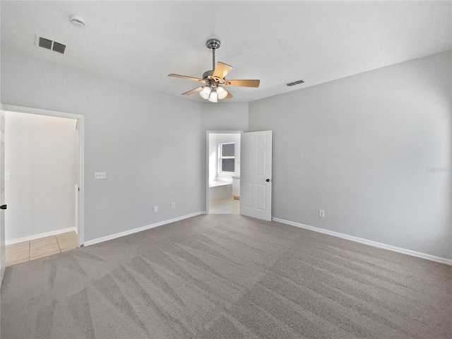 carpeted empty room featuring ceiling fan