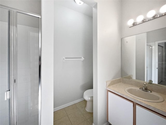 bathroom with vanity, walk in shower, tile patterned floors, and toilet