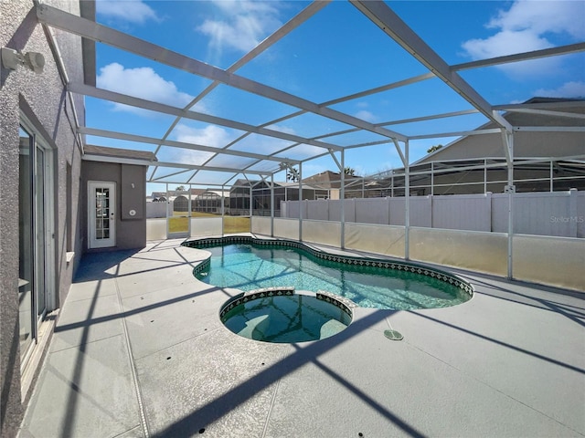 view of swimming pool featuring a lanai, a patio, and an in ground hot tub