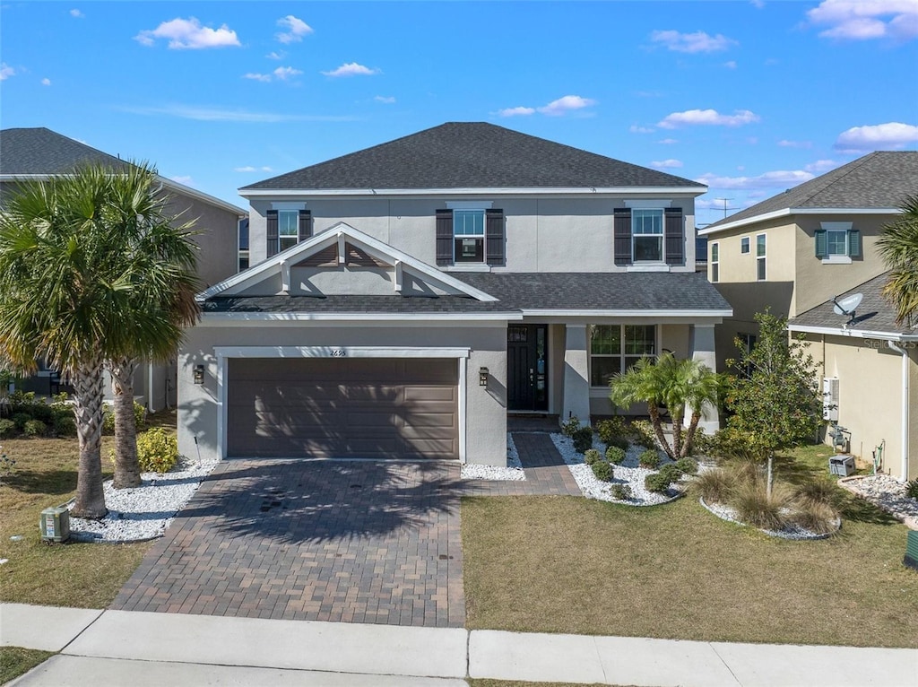 view of front of property featuring a garage and a front yard