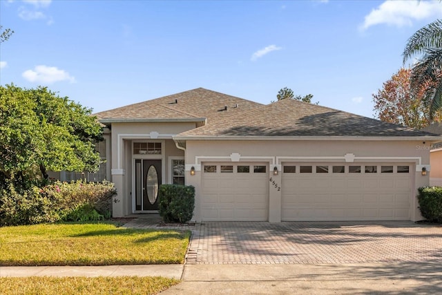 view of front of house with a garage and a front yard