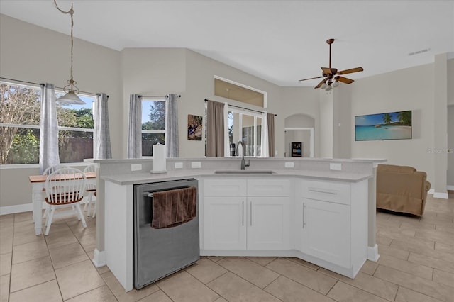 kitchen with dishwasher, an island with sink, sink, white cabinets, and hanging light fixtures