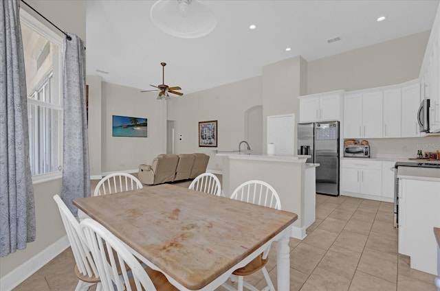 tiled dining area with ceiling fan