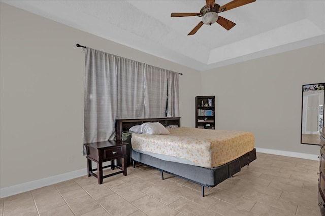 bedroom featuring ceiling fan and a tray ceiling