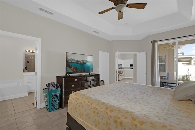 tiled bedroom with connected bathroom, a tray ceiling, access to outside, and ceiling fan