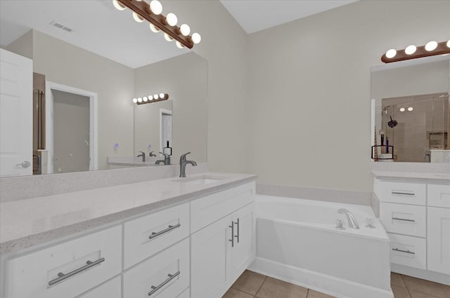 bathroom featuring vanity, separate shower and tub, and tile patterned floors