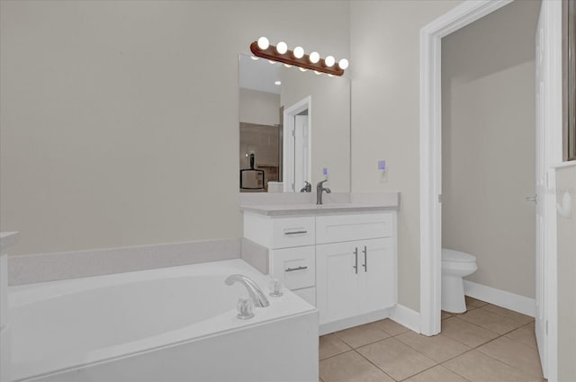 bathroom with tile patterned flooring, vanity, a tub, and toilet