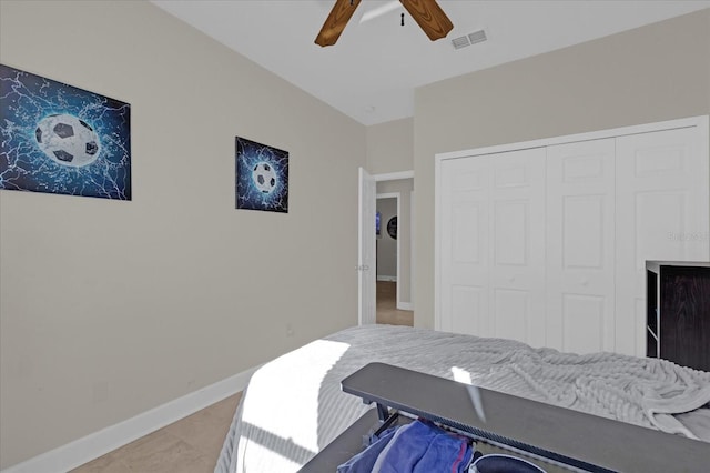 bedroom with light tile patterned floors, ceiling fan, and a closet