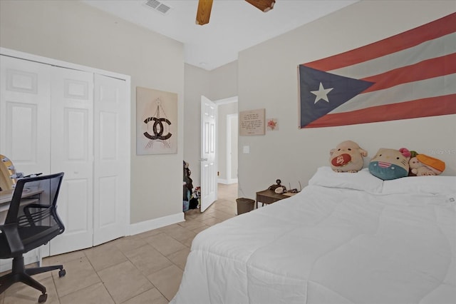 tiled bedroom with ceiling fan and a closet