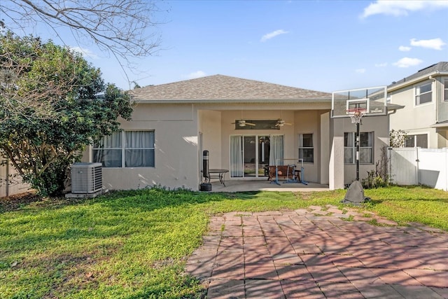 rear view of property with central AC, a patio, ceiling fan, and a lawn