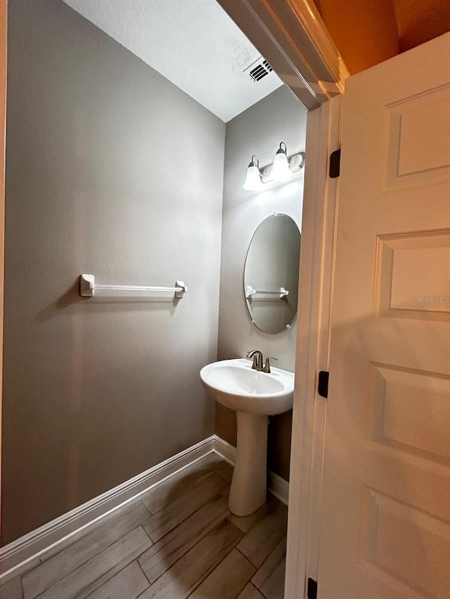 bathroom with hardwood / wood-style flooring