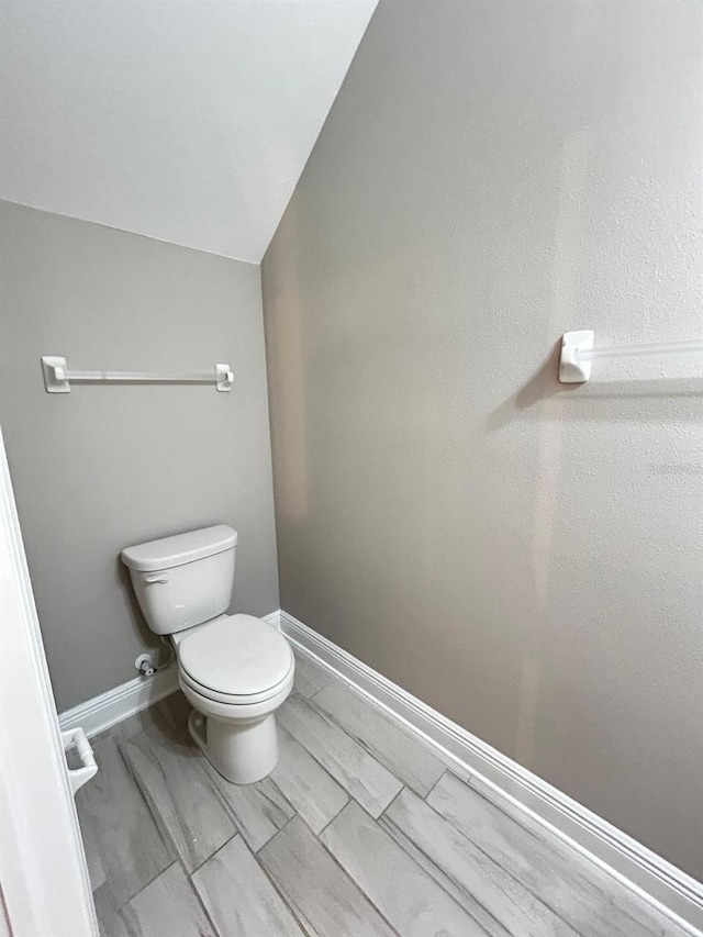 bathroom with vaulted ceiling and toilet