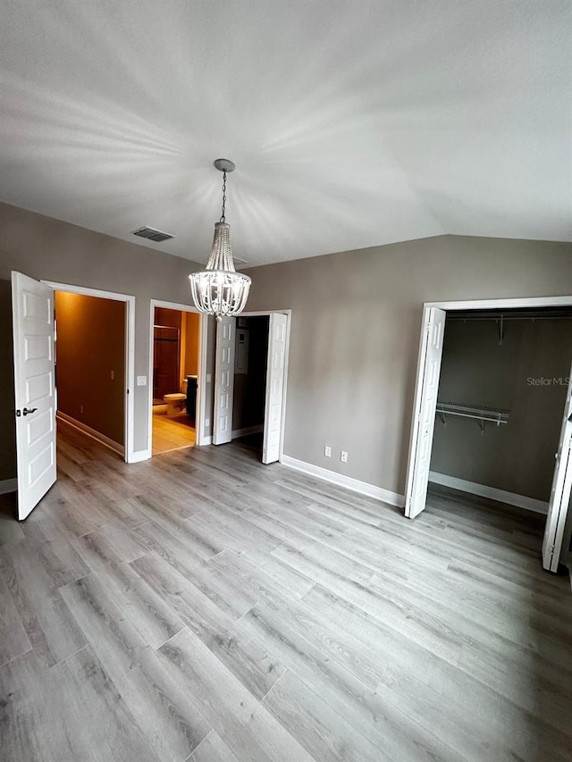 interior space with vaulted ceiling and light wood-type flooring