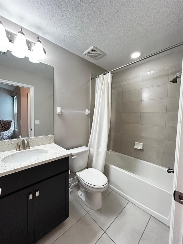 full bathroom featuring shower / tub combo with curtain, vanity, toilet, tile patterned floors, and a textured ceiling