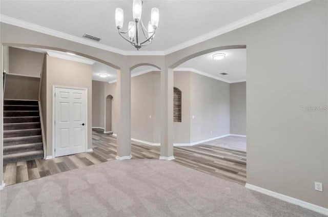 interior space featuring an inviting chandelier, ornamental molding, and light carpet