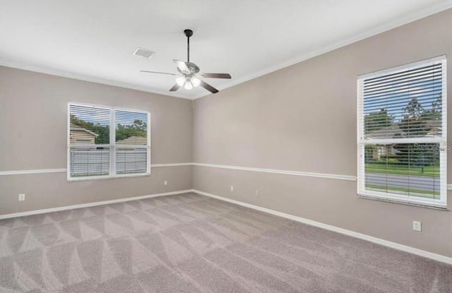 unfurnished room with crown molding, light carpet, and ceiling fan