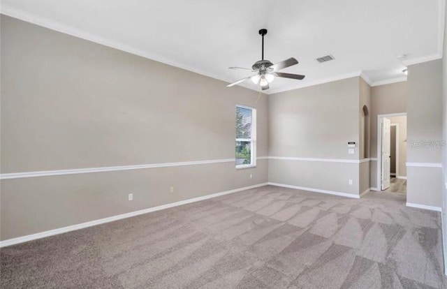 unfurnished room featuring ceiling fan, light colored carpet, and ornamental molding