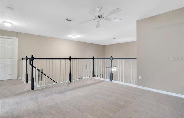 spare room with light carpet and ceiling fan