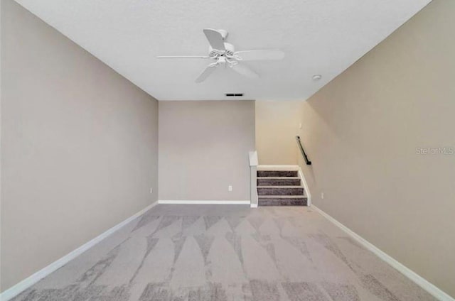 carpeted empty room with ceiling fan