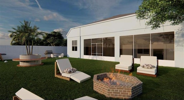 back of house with an outdoor fire pit, a yard, and a sunroom