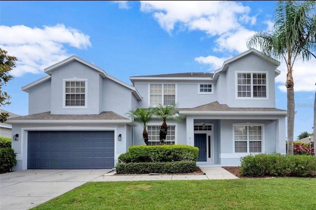 view of front property with a garage and a front lawn