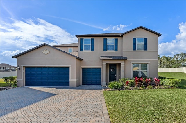 view of front of house with a garage and a front lawn