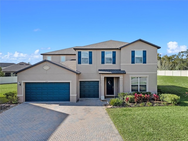 front of property with a garage and a front lawn