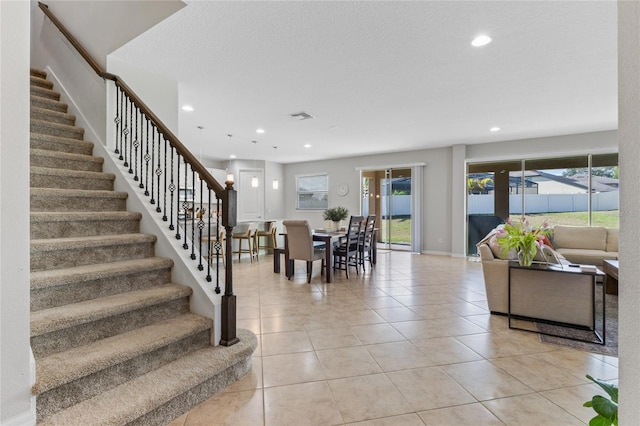 interior space featuring a textured ceiling and light tile patterned floors