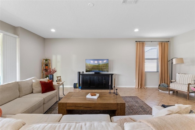 living room with light tile patterned floors and a textured ceiling