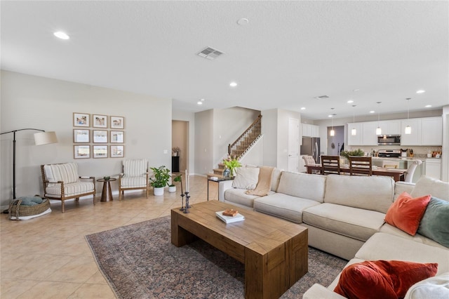 living room featuring light tile patterned floors and a textured ceiling