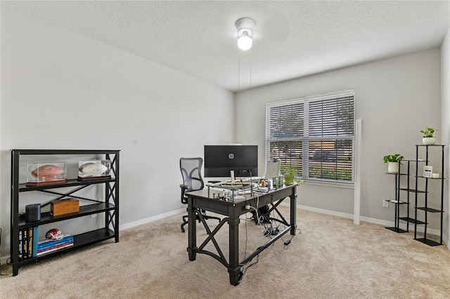 home office featuring light colored carpet and a textured ceiling