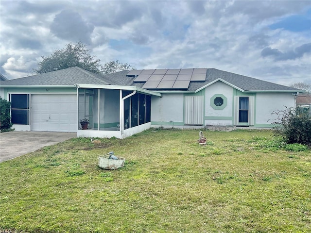 single story home with a garage, a sunroom, a front yard, and solar panels