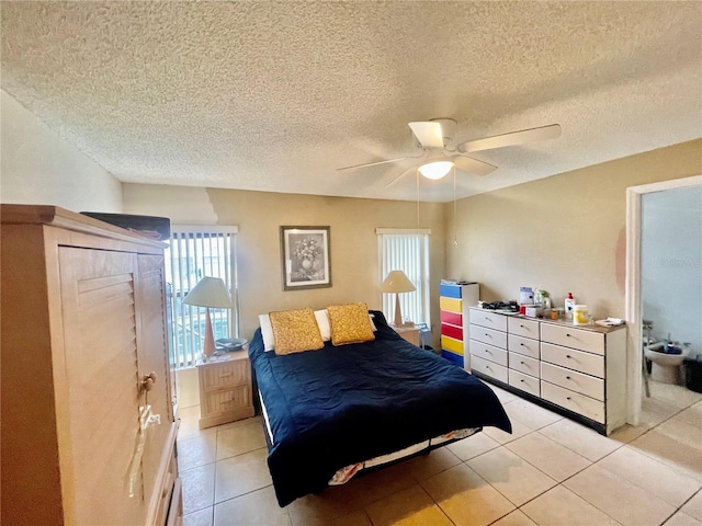 tiled bedroom featuring a textured ceiling and ceiling fan