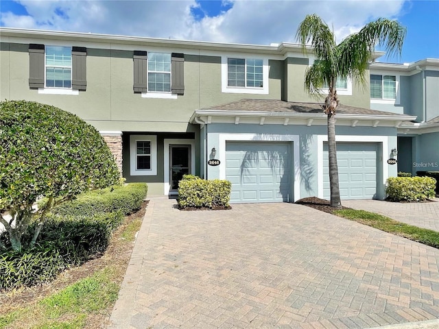 townhome / multi-family property featuring a garage