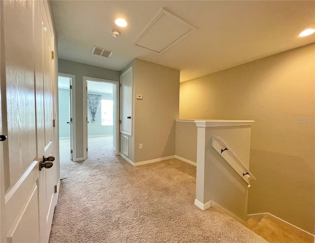 corridor with light colored carpet