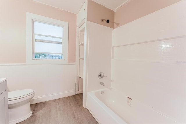 bathroom featuring toilet, vanity, shower / bathtub combination, and wood finished floors