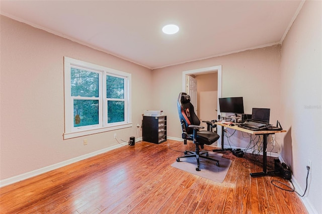 office featuring crown molding, wood finished floors, and baseboards