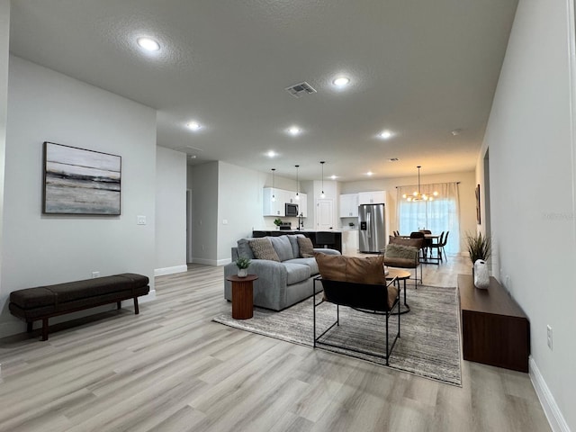150 Marion Oaks Trl, Ocala, FL 34473 - living area featuring a notable chandelier, baseboards, recessed lighting, light wood-style flooring, and visible vents