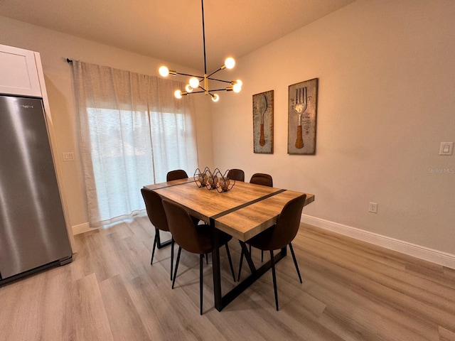 150 Marion Oaks Trl, Ocala, FL 34473 - dining area with baseboards, a notable chandelier, and light wood-style floors