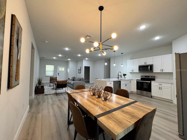 150 Marion Oaks Trl, Ocala, FL 34473 - dining area with light wood-style floors, an inviting chandelier, visible vents, recessed lighting, and baseboards