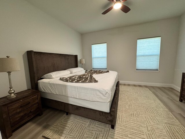 150 Marion Oaks Trl, Ocala, FL 34473 - bedroom with light wood-style floors, baseboards, vaulted ceiling, and ceiling fan