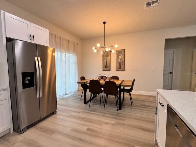 150 Marion Oaks Trl, Ocala, FL 34473 - dining space featuring visible vents, baseboards, light wood finished floors, and a chandelier