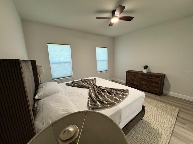 150 Marion Oaks Trl, Ocala, FL 34473 - bedroom with baseboards, a ceiling fan, and wood finished floors