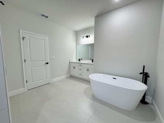 150 Marion Oaks Trl, Ocala, FL 34473 - bathroom with vanity, baseboards, a textured ceiling, visible vents, and a freestanding bath