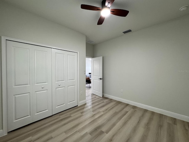 150 Marion Oaks Trl, Ocala, FL 34473 - unfurnished bedroom with light wood-type flooring, a closet, baseboards, and visible vents