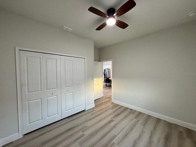 150 Marion Oaks Trl, Ocala, FL 34473 - unfurnished bedroom featuring visible vents, baseboards, stainless steel refrigerator with ice dispenser, and light wood-style floors