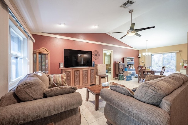 tiled living room with lofted ceiling and ceiling fan with notable chandelier